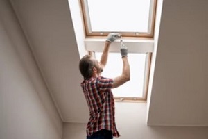 man installing skylight at the corridor