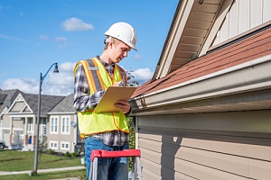 professional roof contractor inspecting a roof