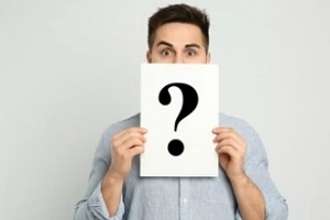 man holding question mark
