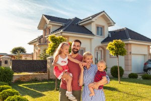 home owners standing outside of their home on a sunny day
