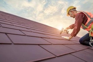 roofer working in special protective work wear gloves