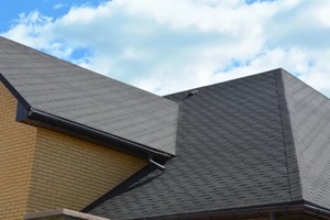 wateproofing roof problem area with asphalt shingles and rain gutter